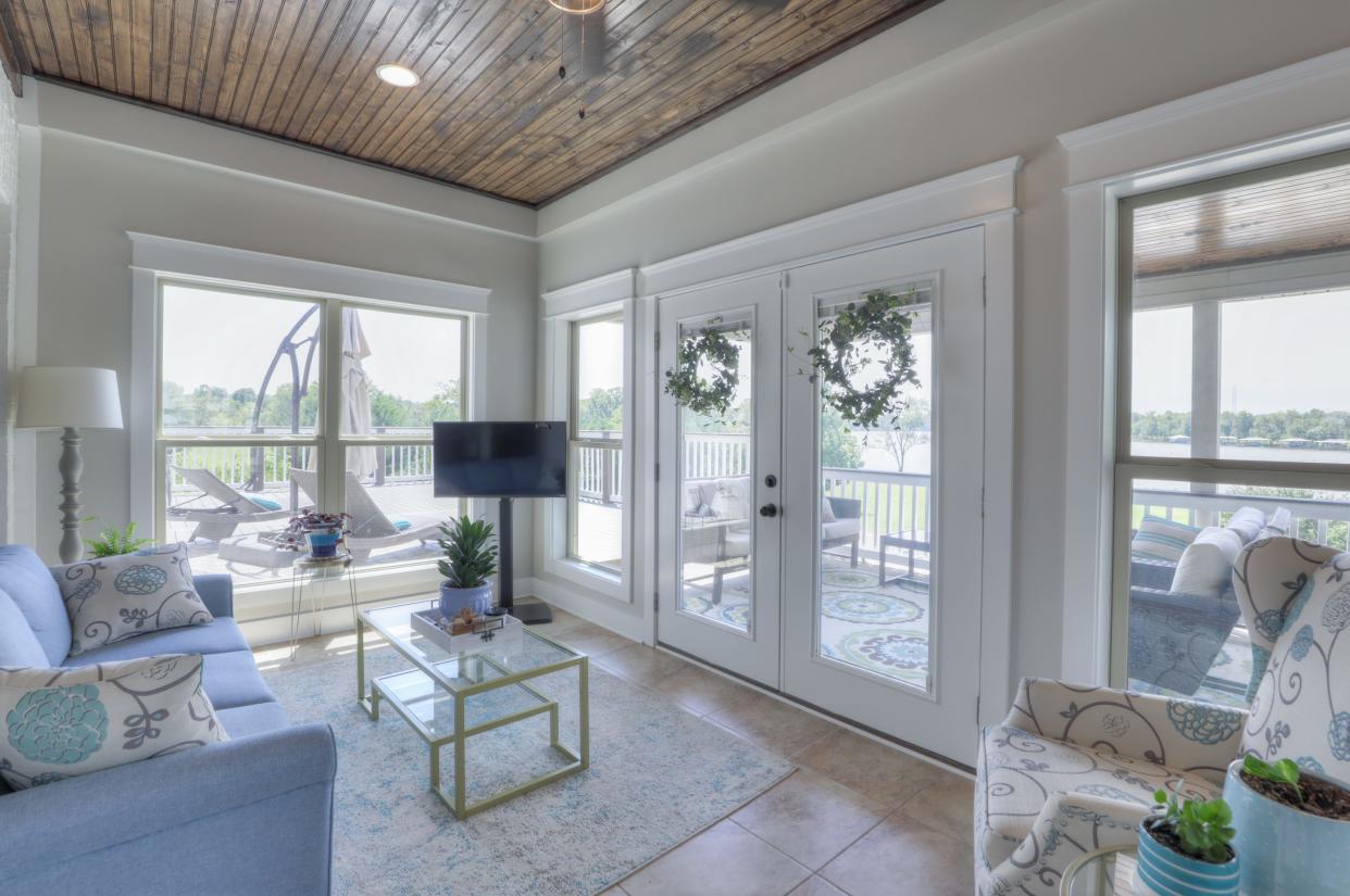 The sunroom at 1062 Lakeshore Drive offers lake views and access to the patio and deck.