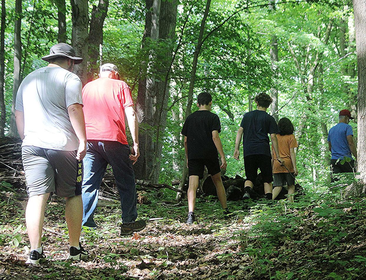 The concept of experiential adventure education in the lakeside and wooded setting of the 100-acre Pathway Farms was first implemented in 2015 with a small group of boys in an after-school program, said Jake Blasdel, the farm's life skills and team-building coordinator. The faith-based organization offers programs to help youth learn life skills. Here, Blasdel leads a group on a walk. TONY ORENDER/For ASHLAND TIMES-GAZETTE