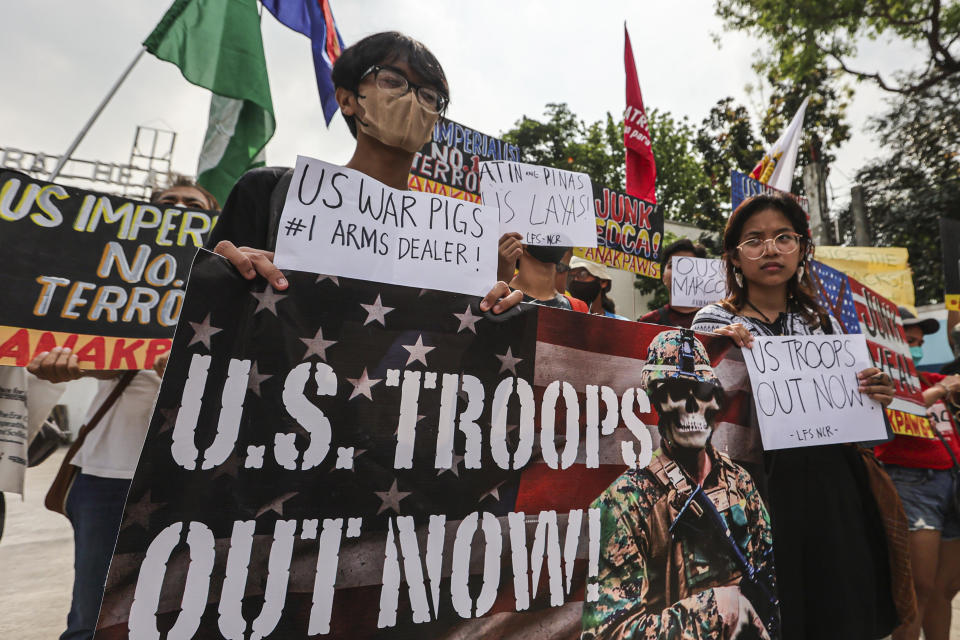 Demonstrators carry placards and shout slogans during a rally in front of Camp Aguinaldo military headquarters in Quezon City, Philippines on Tuesday, April 11, 2023 as they protest against opening ceremonies for the joint military exercise flag called "Balikatan," Tagalog for shoulder-to-shoulder. The United States and the Philippines on Tuesday launch their largest combat exercises in decades that will involve live-fire drills, including a boat-sinking rocket assault in waters across the South China Sea and the Taiwan Strait that will likely inflame China. (AP Photo/Gerard Carreon)