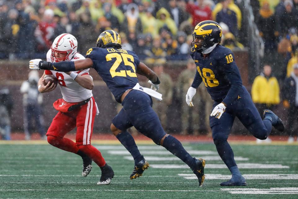 Michigan linebacker Junior Colson (25) tackles Nebraska quarterback Chubba Purdy (6) during the first half at Michigan Stadium in Ann Arbor on Saturday, Nov. 12, 2022.