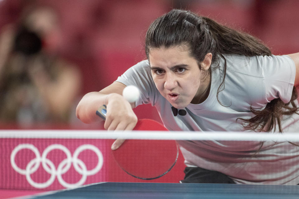 TOKYO, JAPAN - JULY 24: Twelve year old Hend Zaza of Syria, the youngest competitor in the Olympic Games in Tokyo, in action against  Jia Liu of Austria in the Women's Singles  Preliminary Round in the Tokyo Metropolitan Gymnasium at the Tokyo 2020 Summer Olympic Games  on July 24, 2021 in Tokyo, Japan. (Photo by Tim Clayton/Corbis via Getty Images)