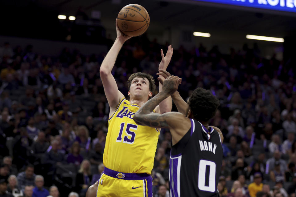 Los Angeles Lakers guard Austin Reaves (15) shoots against Sacramento Kings guard Malik Monk (0) during the first half of an NBA basketball game in Sacramento, Calif, Wednesday, March 13, 2024. (AP Photo/Jed Jacobsohn)