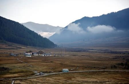 A tourist bus makes its way along the Phobjikha Valley, Bhutan, December 14, 2017. REUTERS/Cathal McNaughton