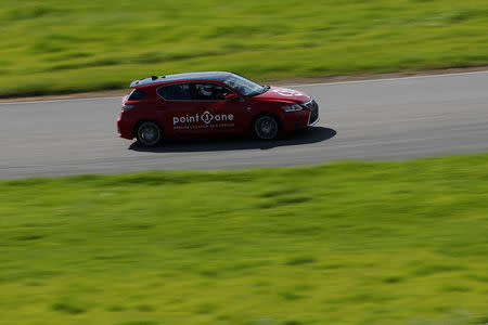 A self-driving car from Point One Navigation drives on the race track during a self-racing cars event at Thunderhill Raceway in Willows, California, U.S., April 1, 2017. REUTERS/Stephen Lam