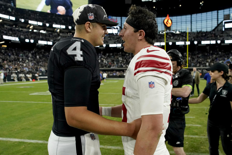 New York Giants quarterback Tommy DeVito (15) greets Las Vegas Raiders quarterback Aidan O'Connell (4) after an NFL football game, Sunday, Nov. 5, 2023, in Las Vegas. (AP Photo/John Locher)