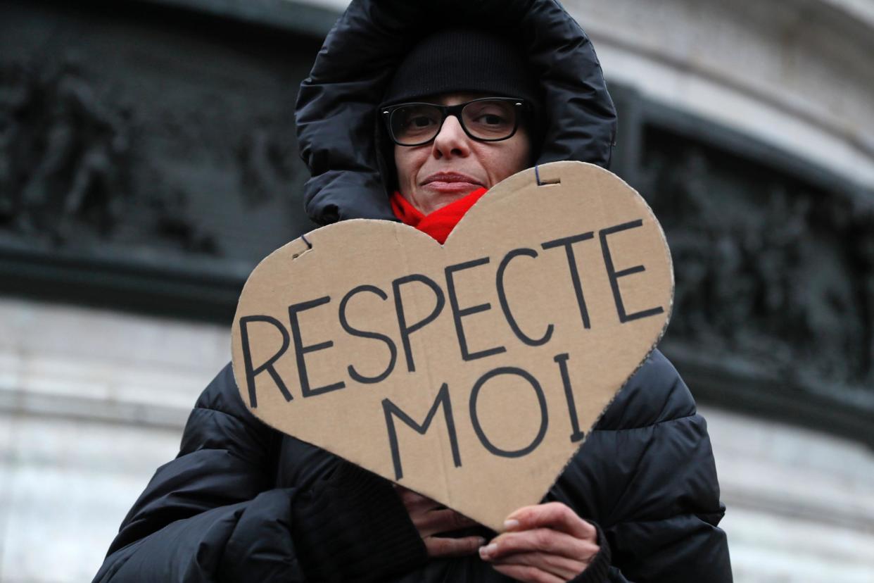 A woman carries a sign reading 'Respect Me' during a demonstration for equal pay between men and women on November 7, 2016, at Place de la Republique in Paris: Thomas Samson/AFP/Getty Images