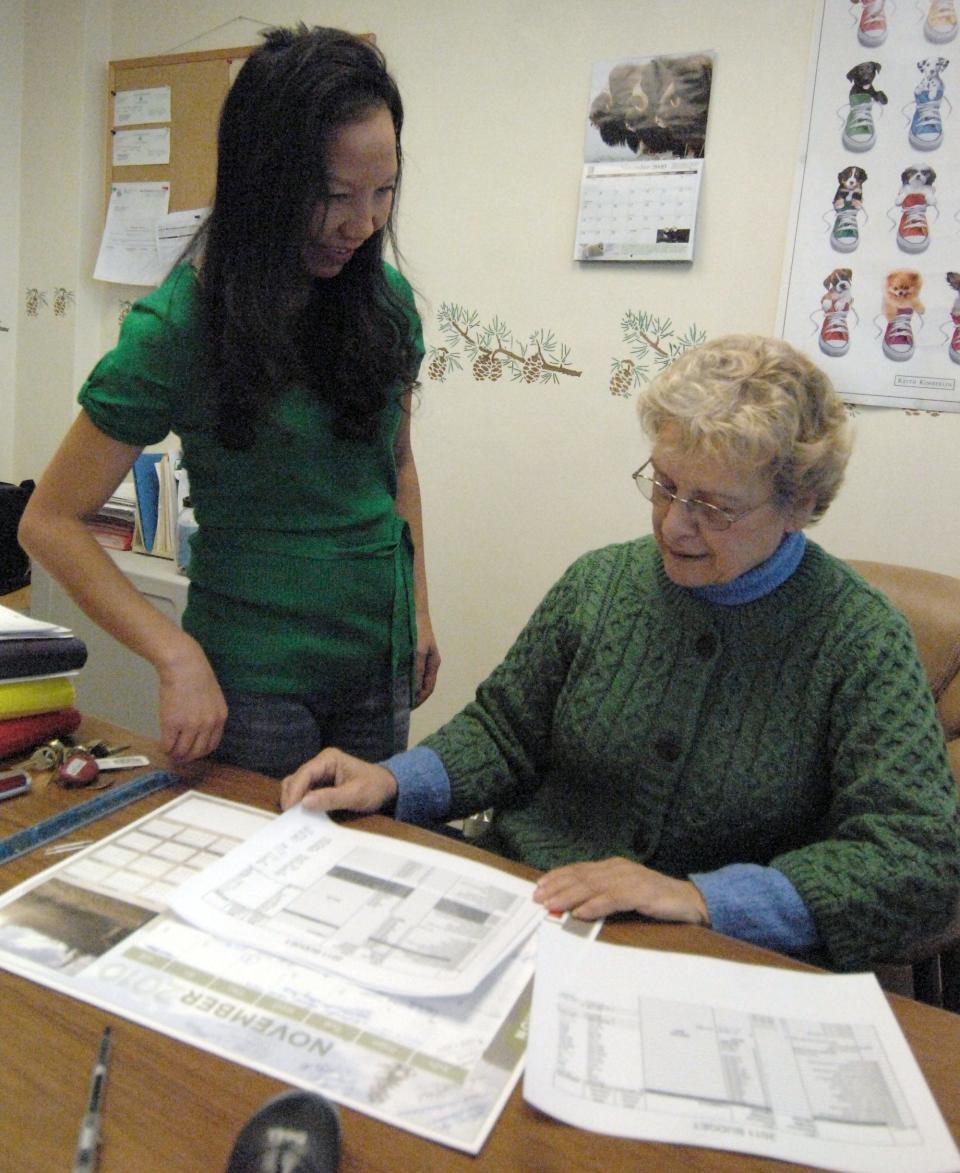 Mao Khang, Southeast Asian coordinator, left, talks with Director of Finance Carolyn Krautkramer at The Women's Community in 2010.