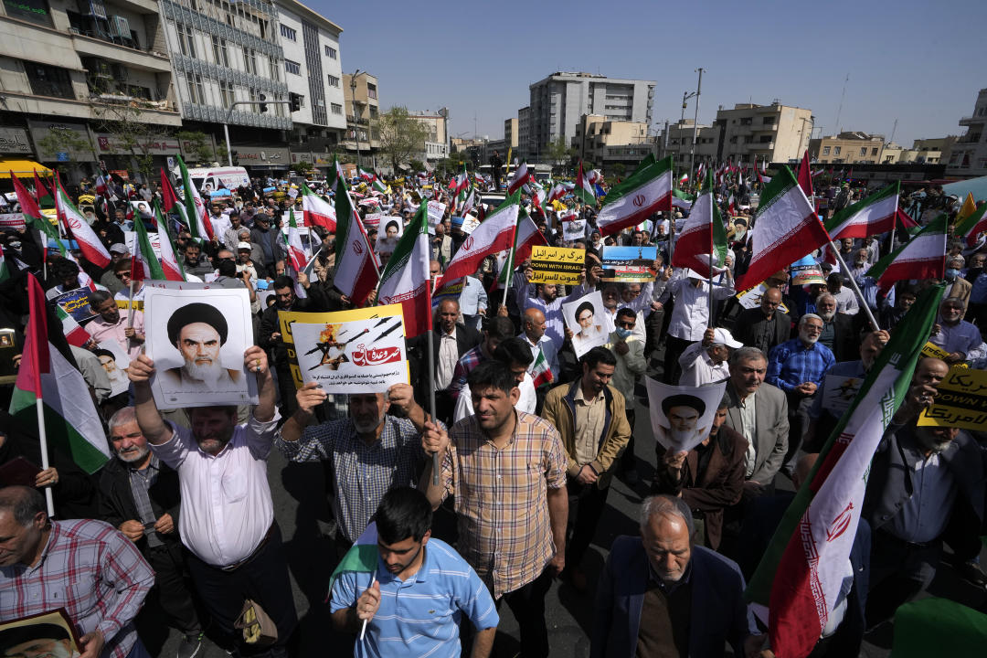 Iranian worshippers attend an anti-Israeli gathering after their Friday prayer in Tehran, Iran, Friday, April 19, 2024. An apparent Israeli drone attack on Iran saw troops fire air defenses at a major air base and a nuclear site early Friday morning near the central city of Isfahan, an assault coming in retaliation for Tehran's unprecedented drone-and-missile assault on the country. (AP Photo/Vahid Salemi)