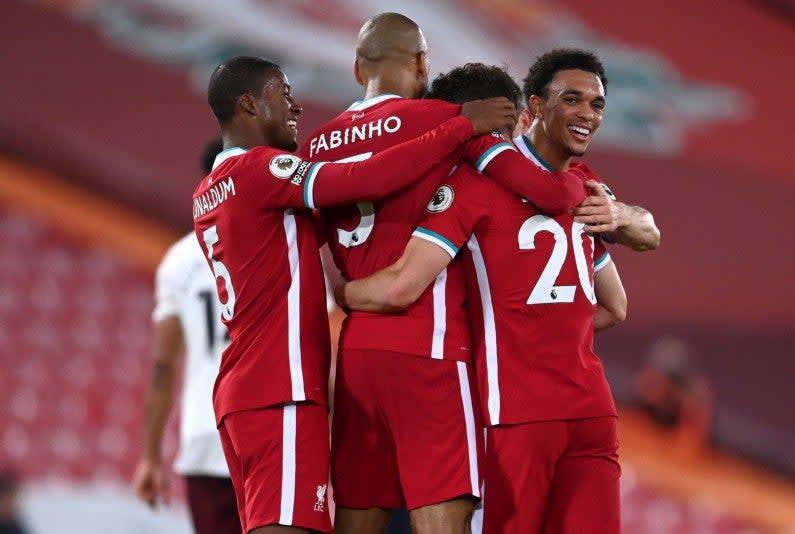 Liverpool players celebrate scoring a goal (PA)