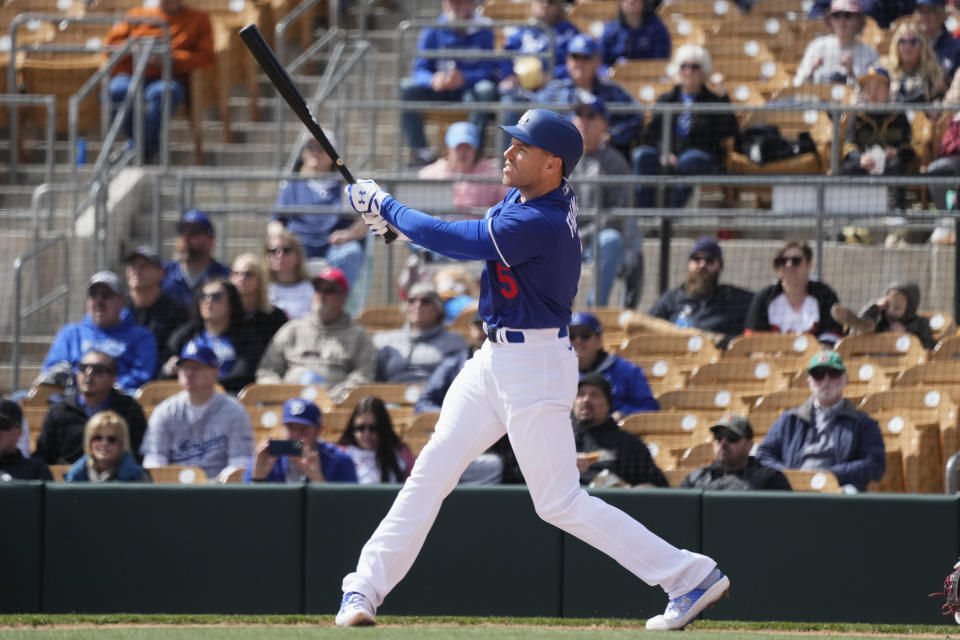 Los Angeles Dodgers' Freddie Freeman watches the flight of his two-run home run against the Arizona Diamondbacks during the first inning of a spring training baseball game Thursday, March 2, 2023, in Phoenix. (AP Photo/Ross D. Franklin)