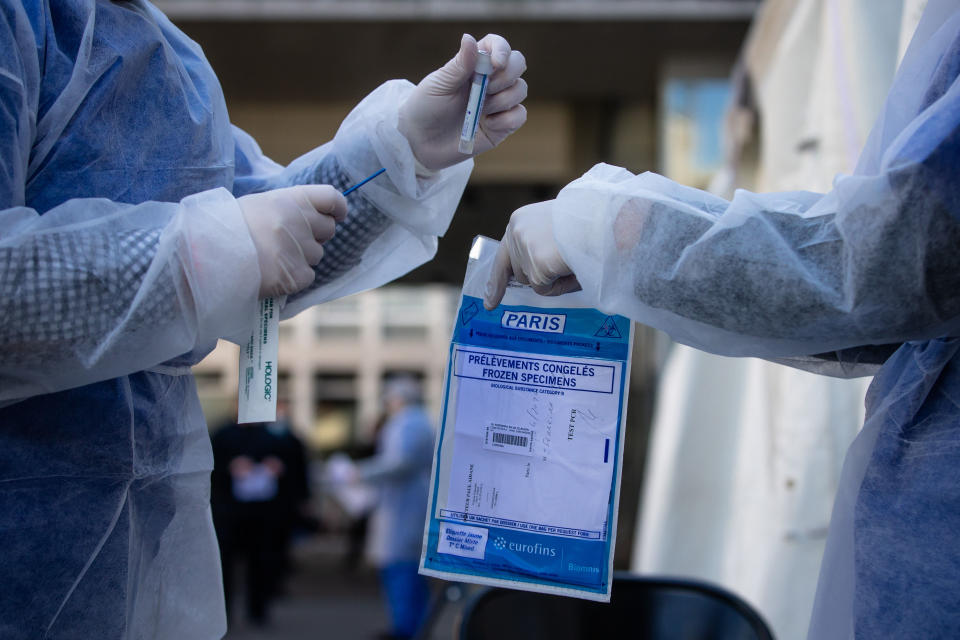 PARIS, April 1, 1010 -- Medical biologists prepare to handle a swab to test a mediacal worker for the COVID-19 disease at a COVID-19 drive-in test center in Paris, France, April 1, 1010. A COVID-19 drive-in screening center has opened at the City Hall of the 17th arrondissement of Paris in partnership with three laboratories in the arrondissement and is dedicated to healthcare professionals. (Photo by Aurelien Morissard/Xinhua via Getty) (Xinhua/ via Getty Images)