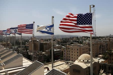 American and Israeli flags flutter in the wind atop the roof of the King David Hotel, in preparation for the upcoming visit of U.S. President Donald Trump to Israel, in Jerusalem May 18, 2017. REUTERS/Ronen Zvulun