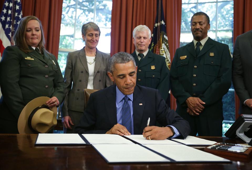 Former U.S. President Barack Obama signs proclamations to designate three new national monuments, including Waco Mammoth National Monument, on July 10, 2015.