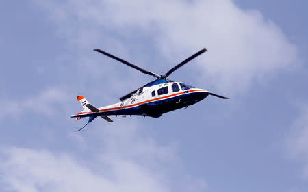 A police helicopter flies as police officers boost security around the capital of Cairo before the funeral of victims of the Palm Sunday bombings of Egyptian Coptic churches, in Cairo, Egypt April 10, 2017. REUTERS/Amr Abdallah Dalsh