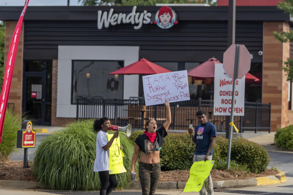 A small group of protesters gather at the scene of an overnight Atlanta Police Department officer involved shooting which where Rayshard Brooks died.  Source:  EPA