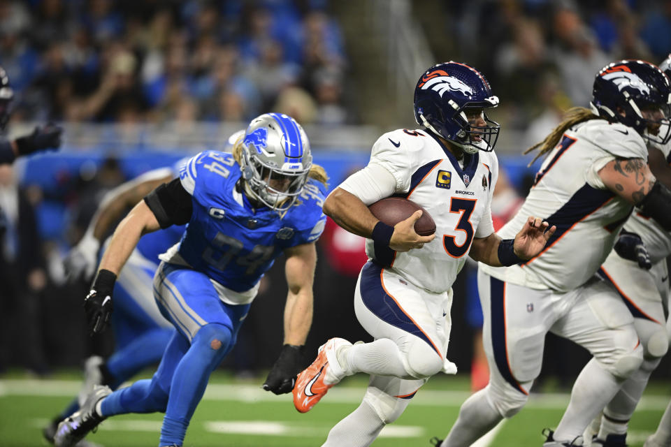 Denver Broncos quarterback Russell Wilson (3) is chased by Detroit Lions linebacker Alex Anzalone (34) during the second half of an NFL football game, Saturday, Dec. 16, 2023, in Detroit. (AP Photo/David Dermer)