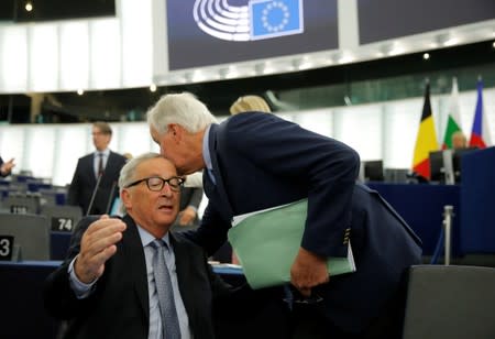 European Commission President Jean-Claude Juncker and European Union's chief Brexit negotiator Michel Barnier arrive to attend a debate on Brexit at the European Parliament in Strasbourg