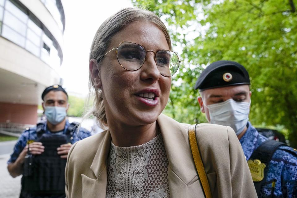 FILE - Russian opposition activist Lyubov Sobol, a close ally of Alexei Navalny, looks at photographers as she arrives at the court in Moscow, Russia, Tuesday, Aug. 3, 2021. Russian imprisoned opposition leader Alexei Navalny, Vladimir Putin's fiercest critic, and eight of his allies — including top aides Lyubov Sobol and Georgy Alburov — were on Tuesday added to the registry by Russia's Federal Financial Monitoring Service. (AP Photo/Alexander Zemlianichenko, File)