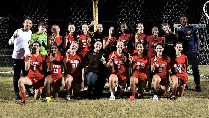 The Seminole Ridge girls soccer squad poses with the district title trophy following their 1-0 overtime victory against Dwyer. The win marked the first district title in program history on Feb. 1, 2023.