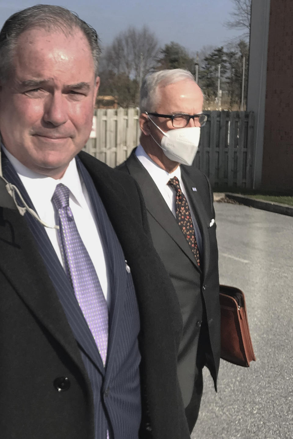 In this photo made on Jan. 13, 2021, Ralph Holloway Thurman, right, walks with an attorney, left, after a preliminary hearing on voter fraud charges against Thurman in East Goshen, Pa. Thurman was held for trial stemming from actions in the 2020 presidential election by casting a ballot in his son's name. A review by The Associated Press in the six battleground states disputed by former President Trump has found fewer than 475 cases of potential voter fraud, a minuscule number that would have made no difference in the 2020 presidential election. Democrat Joe Biden won Arizona, Georgia, Michigan, Nevada, Pennsylvania and Wisconsin and their 79 Electoral College votes by a combined 311,257 votes out of 25.5 million ballots cast for president. (Michael P. Rellahan/Daily Local News via AP)