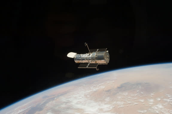 The Hubble Space Telescope, an icon of astronomy, is seen in orbit in May 2009 by the crew of NASA's STS-125 mission. The space telescope is the star of Hubble@25, a new exhibit at the Intrepid Sea, Air and Space Museum in New York City.