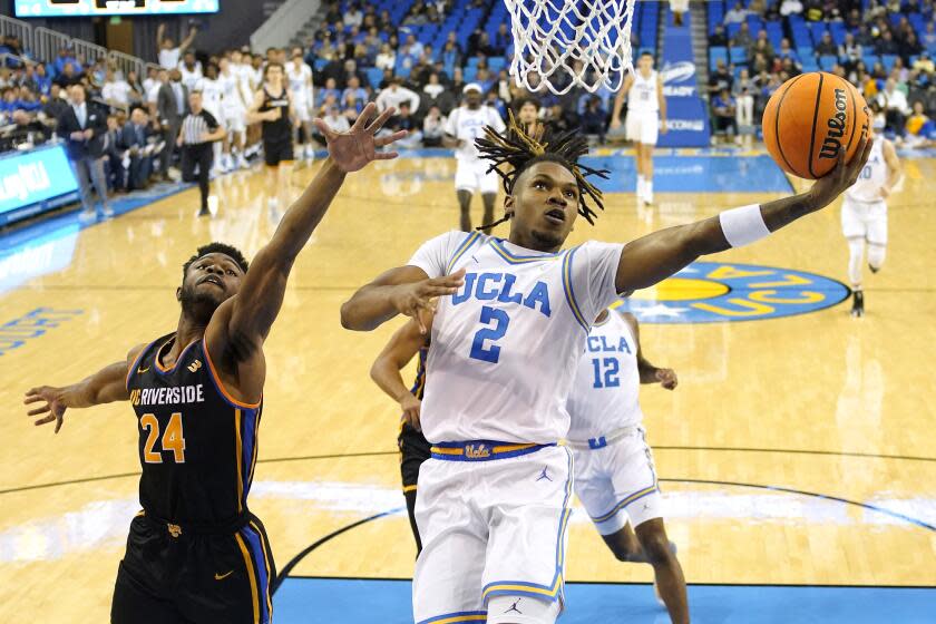 UCLA guard Dylan Andrews, right, shoots over UC Riverside guard Barrington Hargress during the first half at Pauley Pavilion.