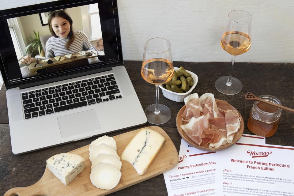 This image released by Murray’s Cheese shows a display of cheeses in front of a laptop showing a virtual class about cheese. In this pandemic climate, there are lots of ways to make this Valentine's Day feel special without putting your health at risk or spending a lot of cash. Murray’s Cheese has expanded their selection of virtual classes, which include one on making cheese boards, and one on creating a “Most Decadent Valentine’s Day.” All the classes can be taken live or bought to view later. (Murray’s Cheese via AP)