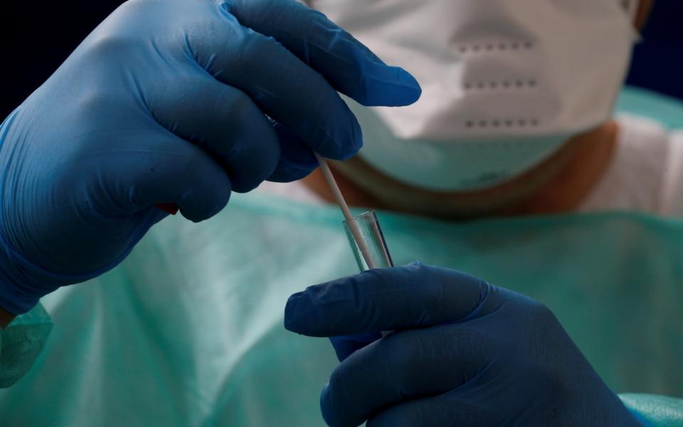 A doctor holds a test tube