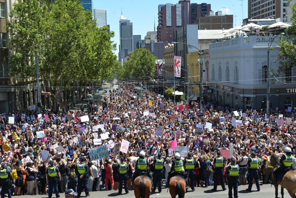 People hold banners as they gather for a rally, protesting US new President Donald Trump following his inauguration on January 21, 2017 in front of the Parliament House, in Melbourne, Australia on January 21, 2017. Rights groups, mostly includes women, marched in solidarity with Americans to speak out against misogyny, bigotry and hatred.&nbsp;