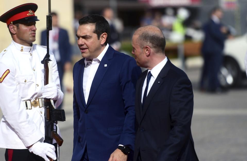 Greece Prime Minister Alexis Tsipras walks by Malta Prime Minister Joseph Muscat, right, on the occasion of the Mediterranean Summit of Southern EU countries in Valetta, Malta, Friday, June 14, 2019. (AP Photo/Jonathan Borg)