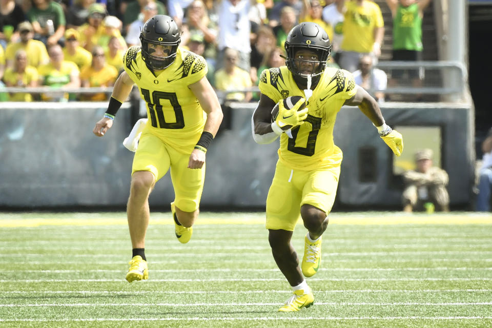 Oregon running back Bucky Irving (0) heads to the end zone trailed by quarterback Bo Nix (10) to score against Portland State during the first half of an NCAA college football game Saturday, Sept. 2, 2023, in Eugene, Ore. (AP Photo/Andy Nelson)