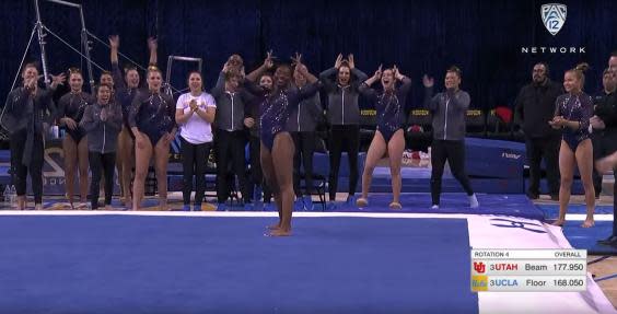 Nia Dennis places a ‘crown’ on her head at the end of her Beyoncé Homecoming-inspired routine (YouTube/UCLA Athletics)