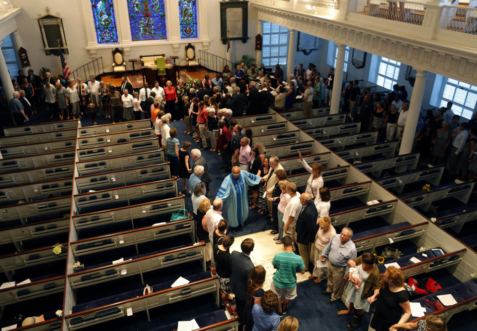 The Rev. Sidney Davis leads a group in prayer during a community prayer service at the Second Presbyterian Church Thursday, June 18, 2015, near the Emanuel AME Church in Charleston, S.C. Shooting suspect Dylann Storm Roof, 21, was captured without resistance in North Carolina Thursday after an all-night manhunt, Charleston's police chief Greg Mullen said. (AP Photo/Stephen B. Morton)