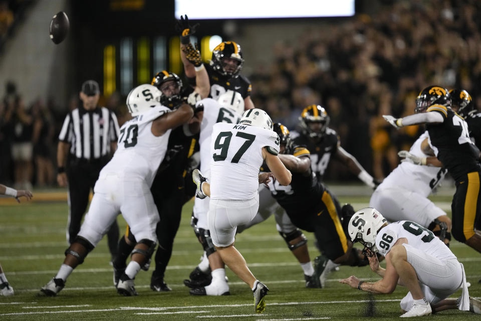 Michigan State place-kicker Jonathan Kim (97) kicks a 58-yard field goal during the first half of an NCAA college football game against Iowa, Saturday, Sept. 30, 2023, in Iowa City, Iowa. (AP Photo/Charlie Neibergall)