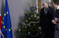 British Prime Minister Theresa May, center, walks past a holiday tree as she leaves the Europa building after a meeting with European Council President Donald Tusk in Brussels, Tuesday, Dec. 11 2018. Top European Union officials on Tuesday ruled out any renegotiation of the divorce agreement with Britain, as Prime Minister Theresa May fought to save her Brexit deal by lobbying leaders in Europe's capitals. (AP Photo/Virginia Mayo)