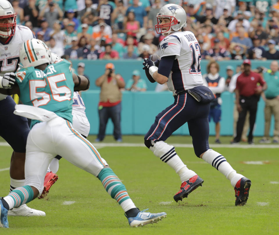 THIS CORRECTS THE IDENTIFICATION OF THE PATRIOTS PLAYER SHOWN TO QUARTERBACK TOM BRADY, AND NOT JULIAN EDELMAN - New England Patriots quarterback Tom Brady gets ready to throw a touchdown pass to wide receiver Julian Edelman (not shown), during the first half of an NFL football game against the Miami Dolphins, Sunday, Dec. 9, 2018, in Miami Gardens, Fla. (AP Photo/Lynne Sladky)