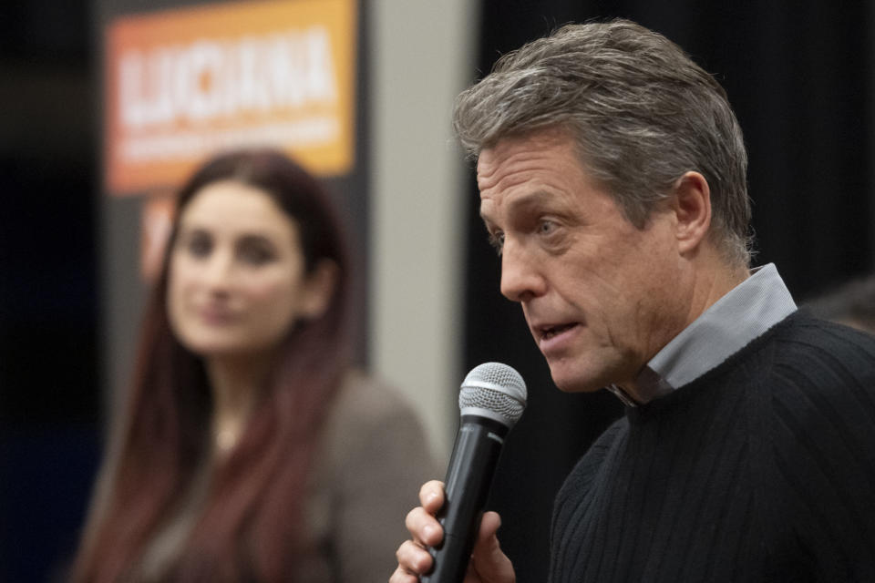 Britain's Liberal Democrat Party candidate for Finchley and Golders Green, Luciana Berger, left, listens to actor Hugh Grant speak during a canvassing event in north London, Sunday Dec. 1, 2019, ahead of the general election on Dec. 12. (David Mirzoeff/PA via AP)