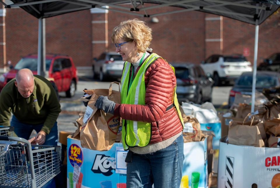 Mary Siegel, president of the board of directors at Open Table, helps out during distribution of Thanksgiving meals, Nov. 14, 2023.