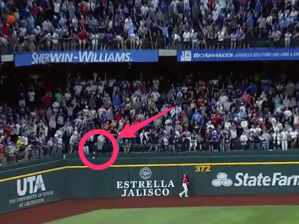 A fan jumps out of the stands to attempt to retrieve Aaron Judge's 62nd home run of the season.