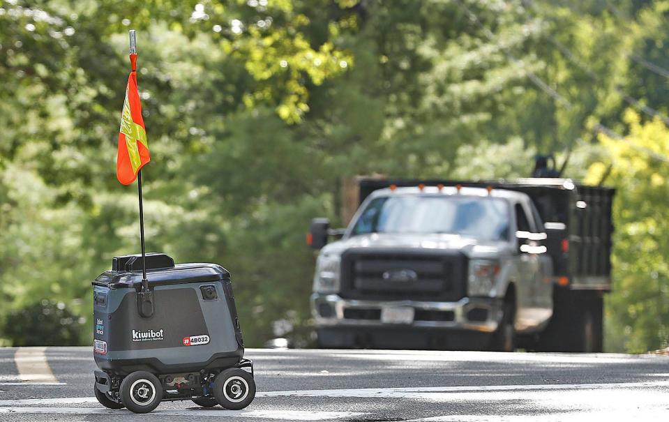 Kiwibot, a semi-autonomous robot, delivers food on the campus of Curry College in Milton.