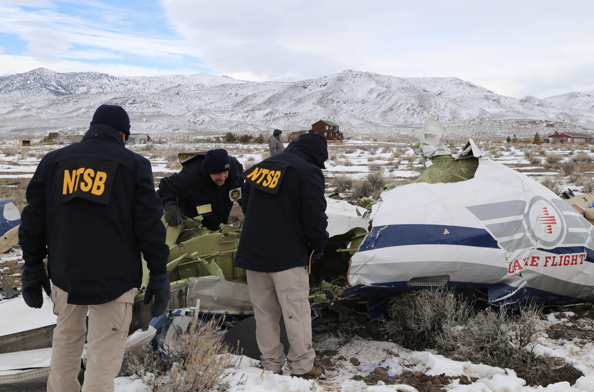 Investigators at a crash scene after a Care Flight medical transport plane crashed near Stagecoach, Nevada, killing all five on board (National Transportation Safety Board)