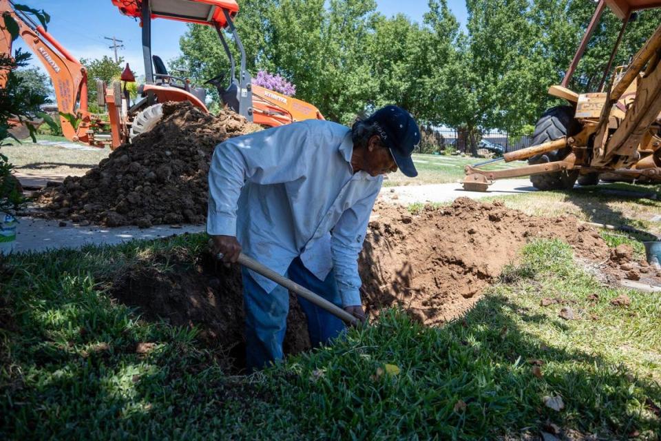 Victor Trujillo, the gravedigger at the Greater Sacramento Muslim Cemetery, prepares a site on June 27.