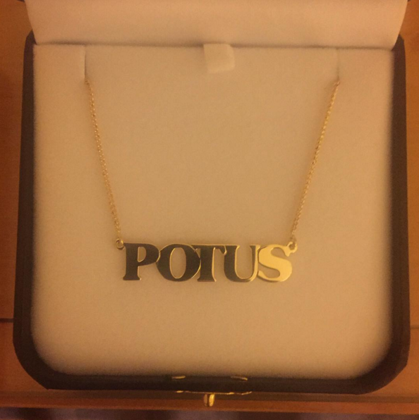 Katy Perry’s gift to Hillary Clinton: a gold “POTUS” necklace. 