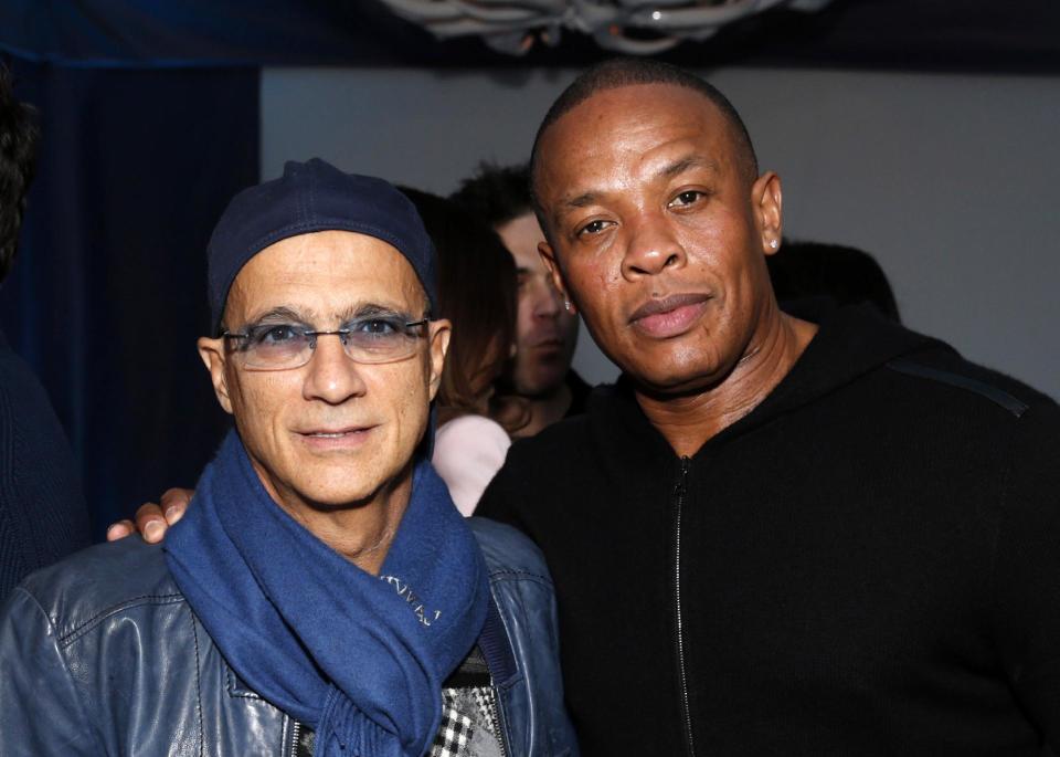 FILE - This Feb. 10, 2013 file photo shows music industry entrepreneur Jimmy Iovine, left, and hip-hop mogul Dr. Dre at a Grammy Party in Los Angeles. It’s as if anything Iovine and Dre touches turns to gold: The dynamic duo marked epic-level success when they introduced Eminem to the music world 15 years ago, and their lucrative Beats by Dre business reached blockbuster heights following reports on Thursday, May 8, 2014, that Apple plans to by the headphone’s parent company, Beats Electronics, for $3.2 billion. (Photo by Todd Williamson/Invision/AP, file)