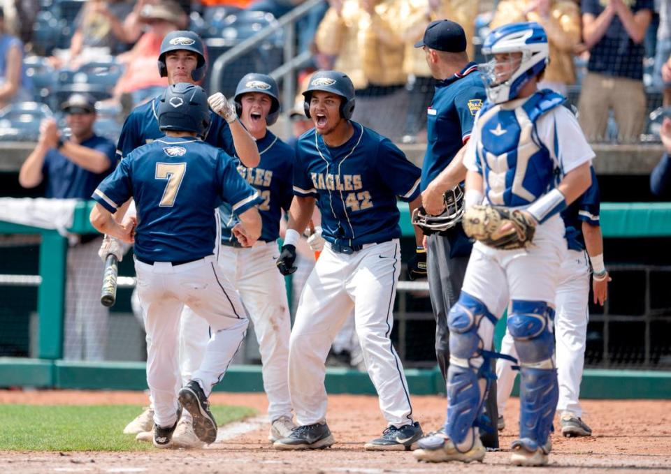 Bald Eagle Area players cheer on Heath Basalla as he scores a run from Tayten Yoder’s triple during the PIAA Class 2A championship game against Mount Union at Medlar Field on Saturday, June 17, 2023.