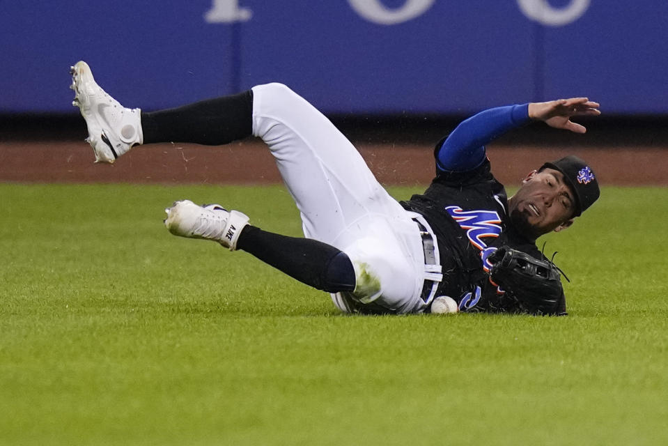 New York Mets left fielder Rafael Ortega loses control of a ball hit by Atlanta Braves' Matt Olson for a single during the fourth inning of a baseball game Friday, Aug. 11, 2023, in New York. (AP Photo/Frank Franklin II)