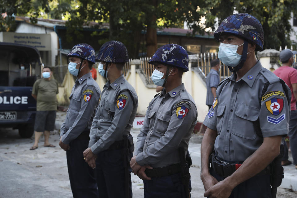Police officers provide security as Buddhist monk Wirathu, arrives at a police station in Yangon, Myanmar, Monday Nov. 2, 2020. Wirathu, a nationalist Buddhist monk in Myanmar noted for his inflammatory rhetoric, has surrendered to police, who have been seeking his arrest for over a year for insulting comments he made about the country’s leader, State Counsellor Aung San Suu Kyi. (AP Photo/Thein Zaw)