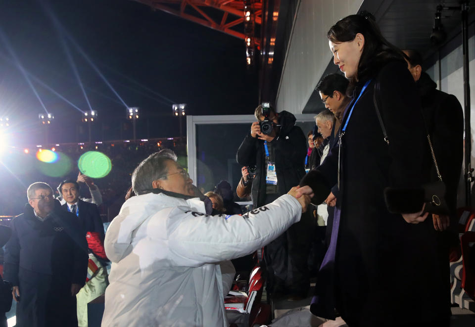 FILE - South Korean President Moon Jae-in, front left, shakes hands with North Korean leader Kim Jong Un's younger sister Kim Yo Jong during the opening ceremony of the 2018 Winter Olympics in Pyeongchang, South Korea on Feb. 9, 2018. North Korea basked in the global limelight during the last Winter Games in South Korea, with hundreds of athletes, cheerleaders and officials pushing hard to woo their South Korean and U.S. rivals in a now-stalled bid for diplomacy. Four years later, as the 2022 Winter Olympics come to its main ally and neighbor China, North Korea isn't sending any athletes and officials because of coronavirus fears. (Kim Ju-sung/Yonhap via AP, File)