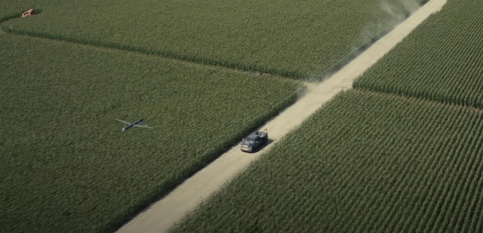 A car driving through a cornfield