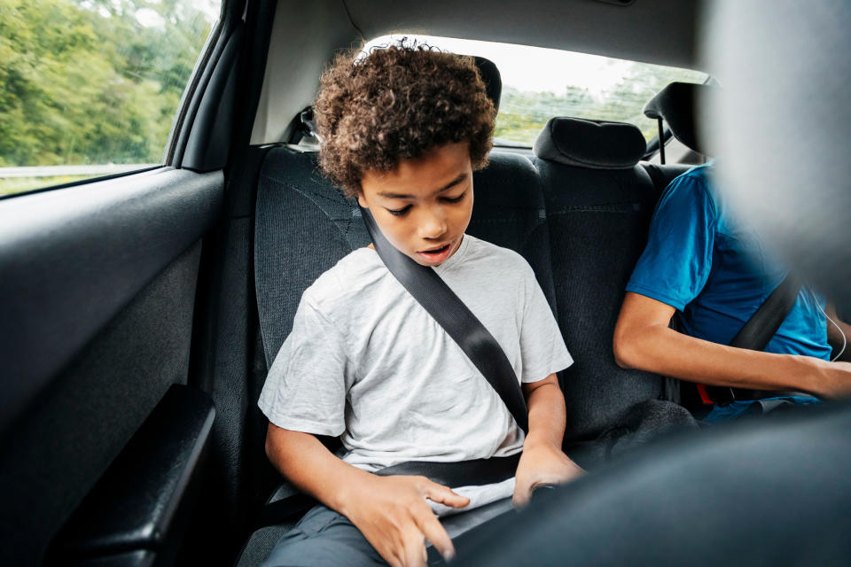 A kid sitting in the backseat.